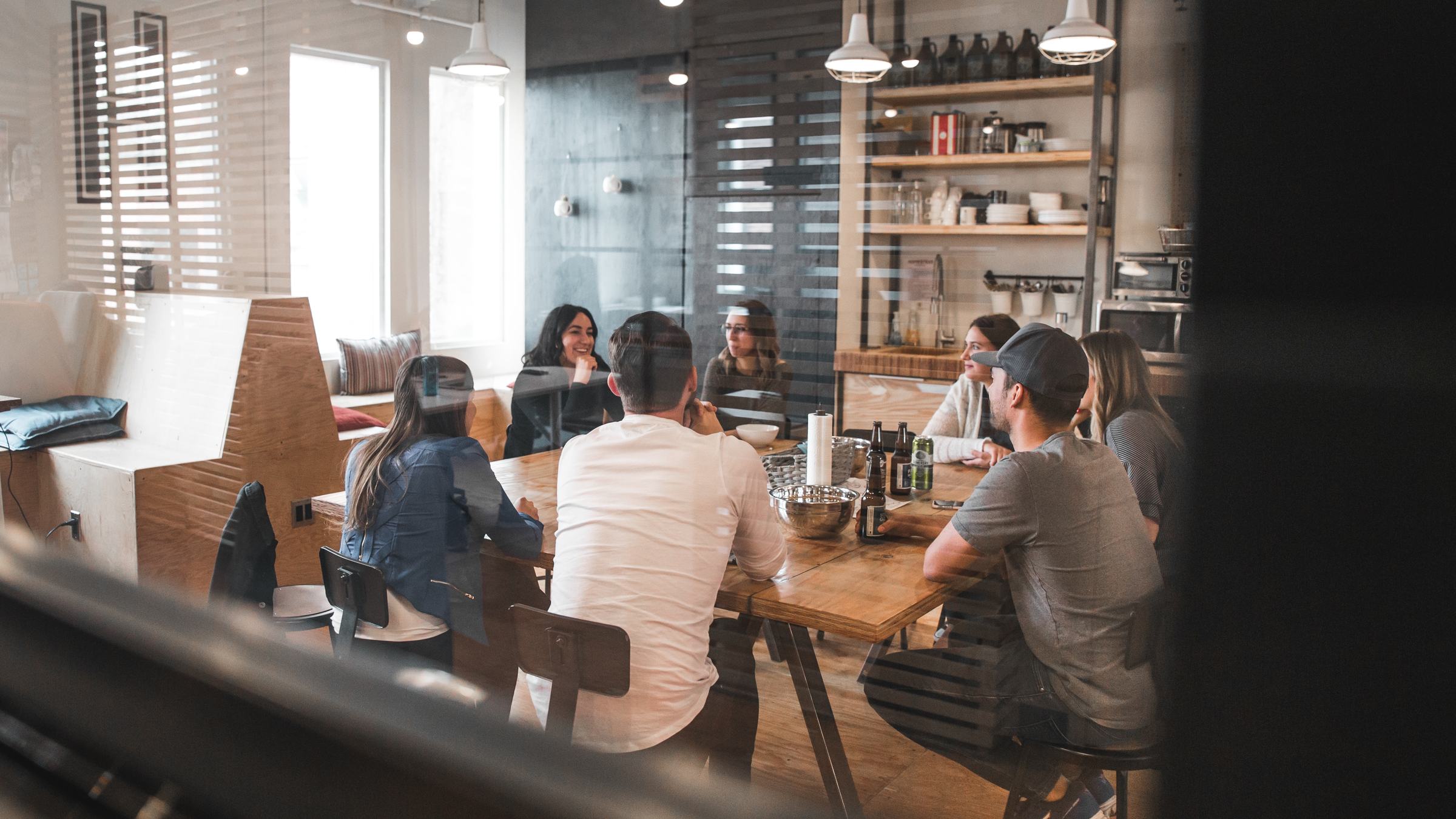 A team gathered around a table in conversation