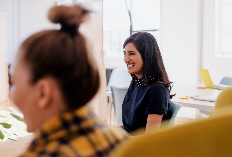Colleagues talking in a bright office