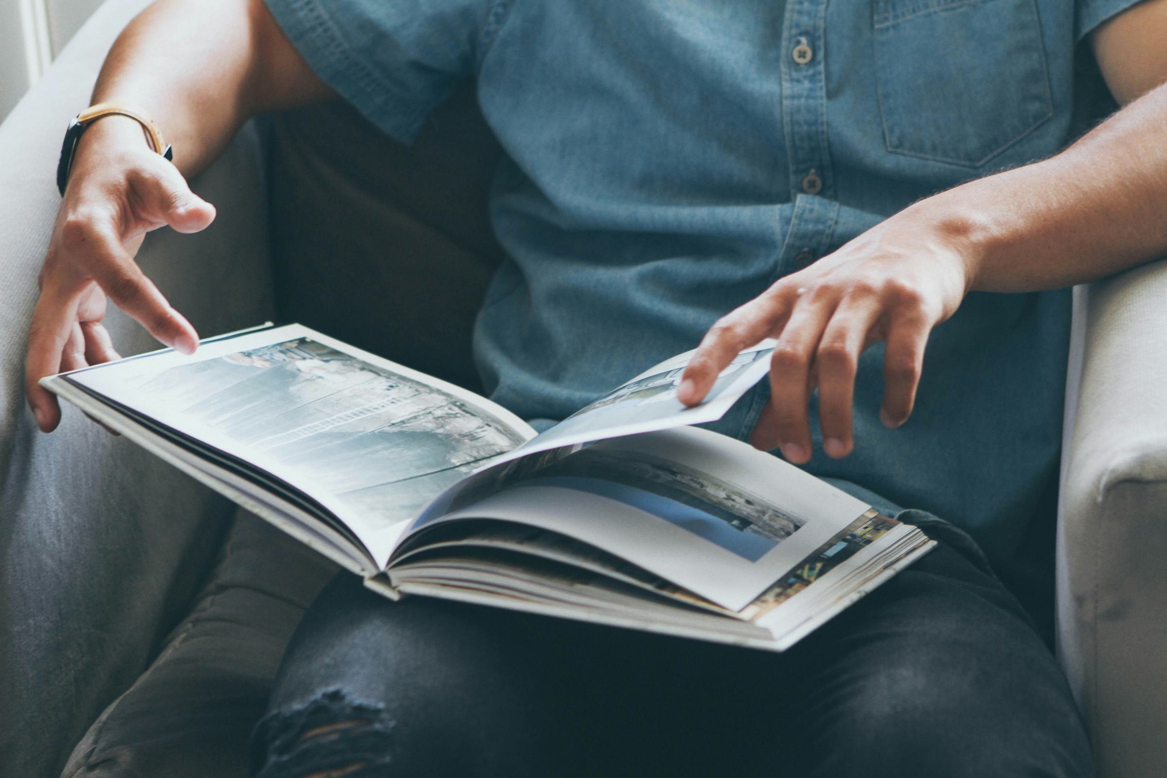 Two people reading through a book together
