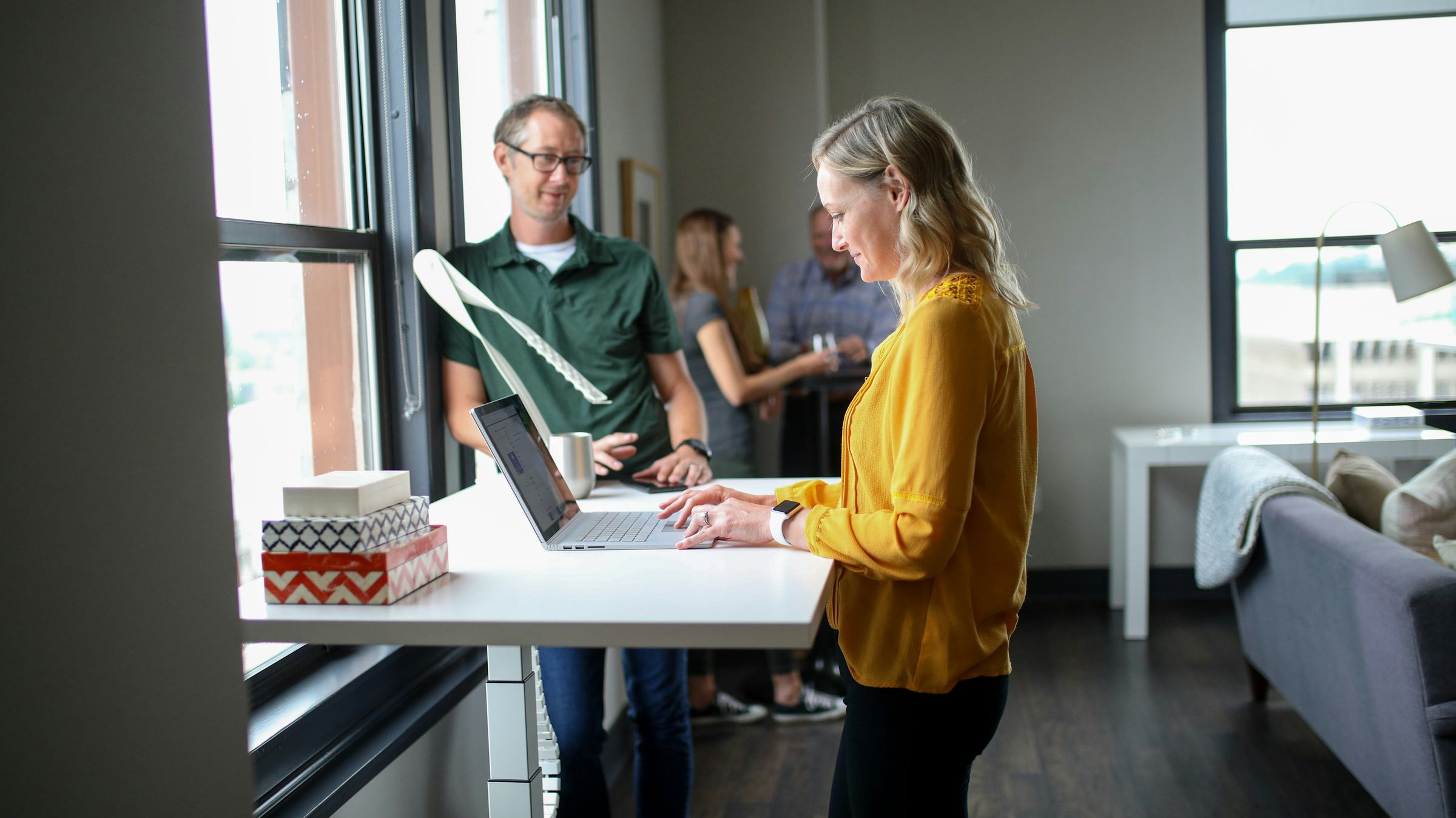 Colleagues working together at a standing desk