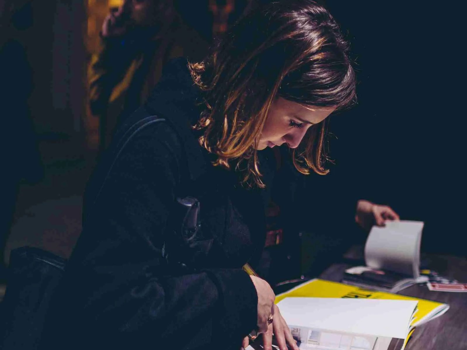 Someone working at a desk in low light